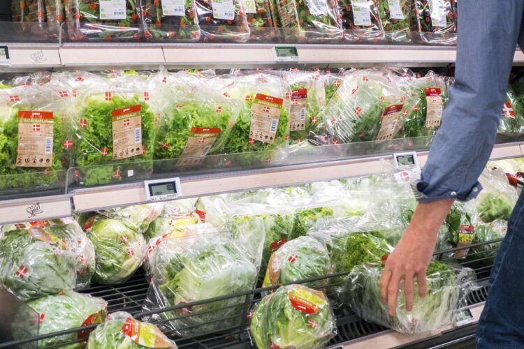 Buying lettuce in a grocery store. Via Rawpixel